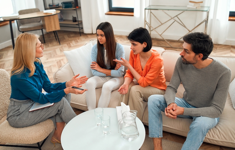 People participate in family therapy at an addiction treatment center.