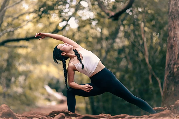 A person practices yoga as part of a holistic approach to relapse prevention.