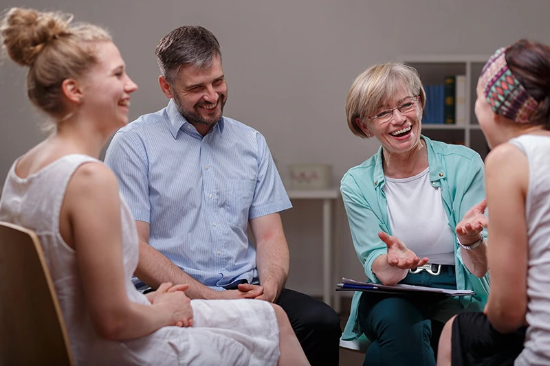 People participate in therapy at a drug rehab center.